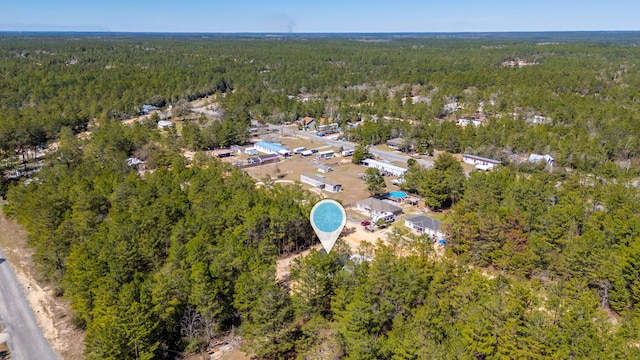 drone / aerial view featuring a view of trees