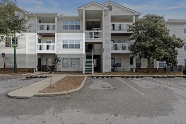 view of property featuring uncovered parking