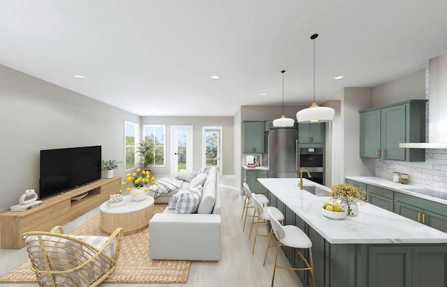 living area with light wood-style floors and recessed lighting