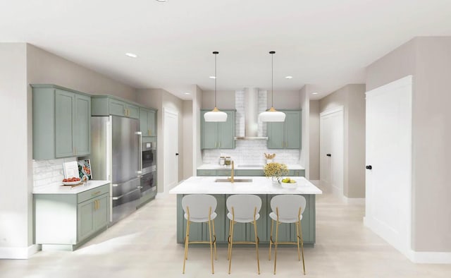 kitchen with stainless steel appliances, light countertops, hanging light fixtures, a sink, and wall chimney range hood