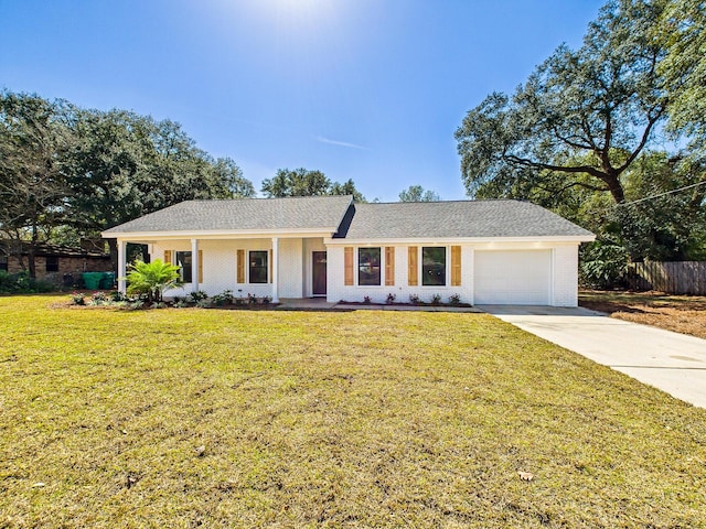 single story home with fence, a front lawn, concrete driveway, a garage, and brick siding