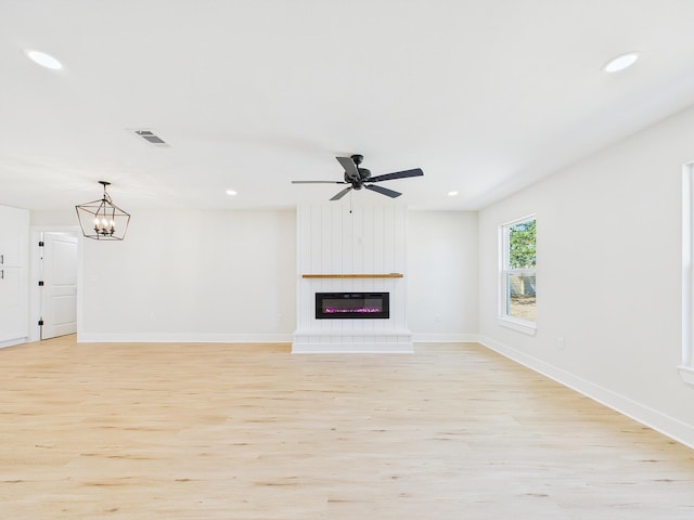 unfurnished living room with light wood finished floors, visible vents, recessed lighting, and a fireplace