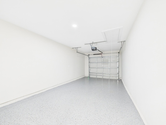 garage with a garage door opener and baseboards