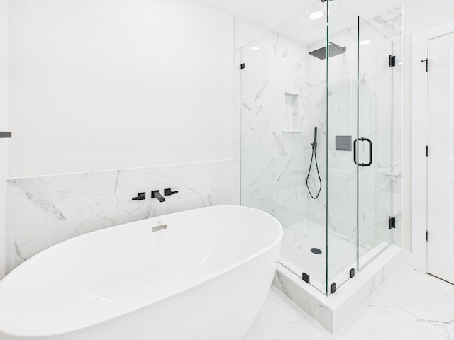 bathroom with a marble finish shower, a wainscoted wall, marble finish floor, and a freestanding tub