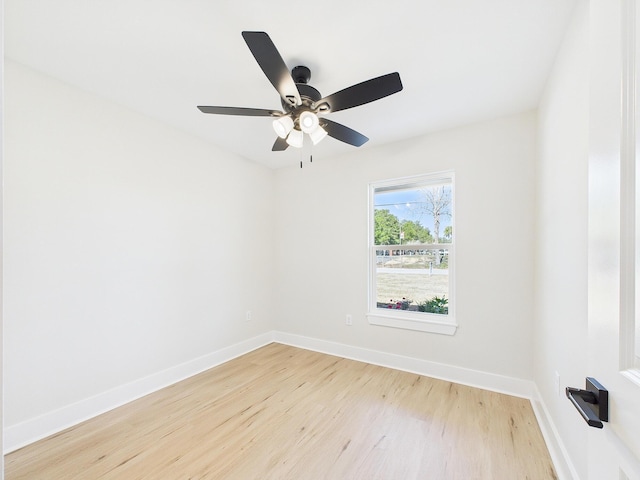 unfurnished room with ceiling fan, baseboards, and wood finished floors