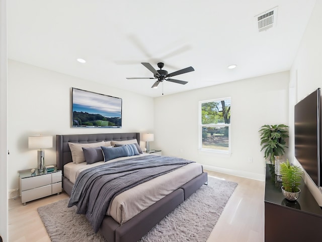 bedroom with light wood finished floors, visible vents, baseboards, recessed lighting, and a ceiling fan