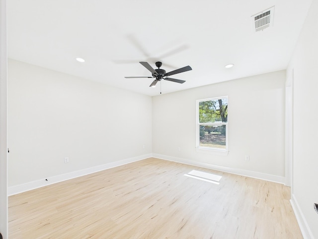 unfurnished room featuring baseboards, visible vents, and light wood finished floors