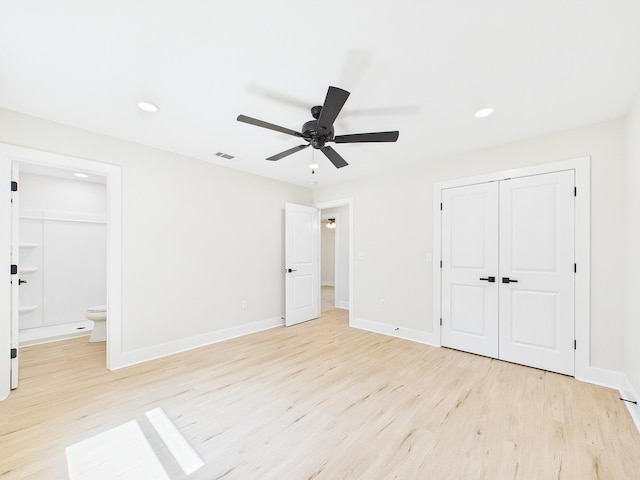 unfurnished bedroom with visible vents, baseboards, light wood-style floors, and a closet