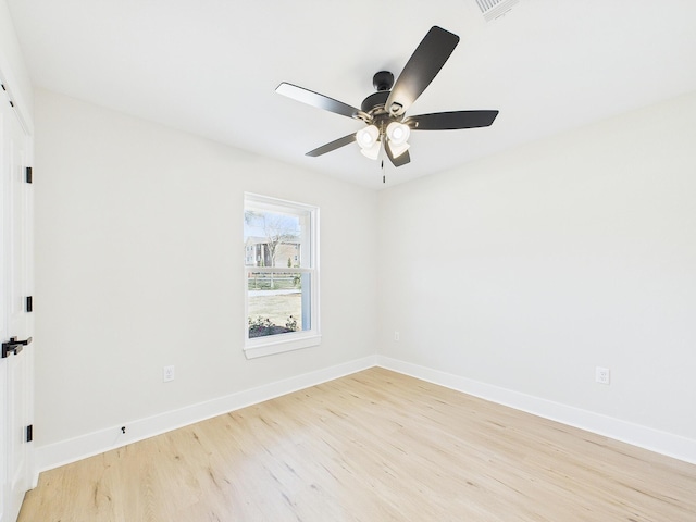 spare room with visible vents, baseboards, light wood-style floors, and a ceiling fan