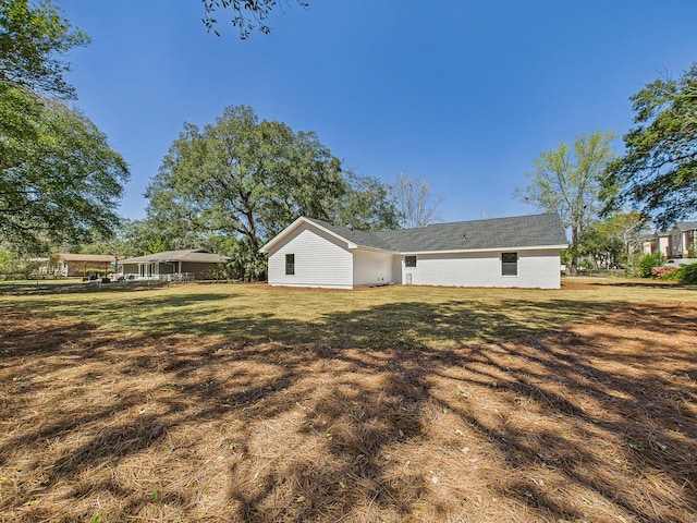 back of property with a lawn