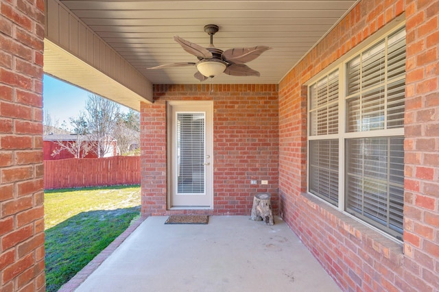 view of patio / terrace with fence and a ceiling fan