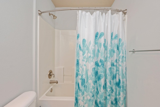 bathroom with toilet and shower / tub combo with curtain