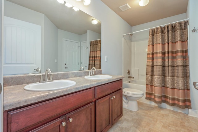 full bath with toilet, double vanity, visible vents, and a sink