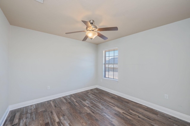 spare room with ceiling fan, baseboards, and dark wood-style flooring