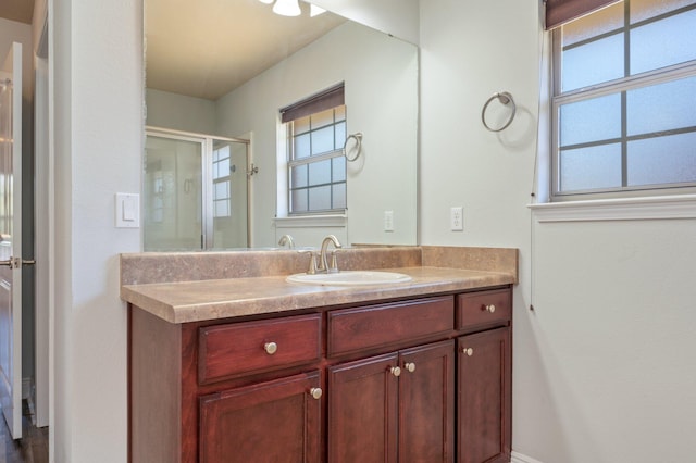 bathroom featuring a shower stall and vanity