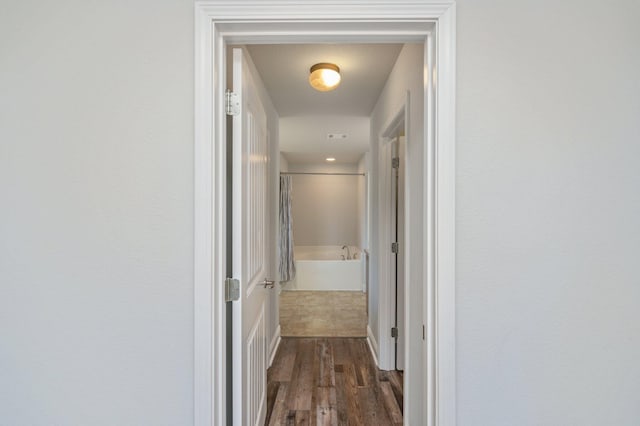 hallway with dark wood-style flooring