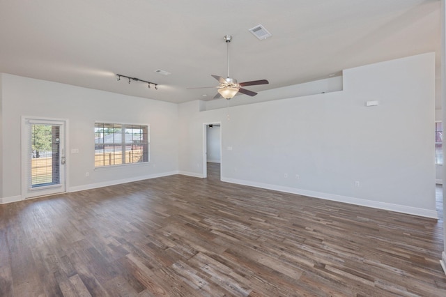 spare room featuring dark wood-style flooring, visible vents, ceiling fan, track lighting, and baseboards