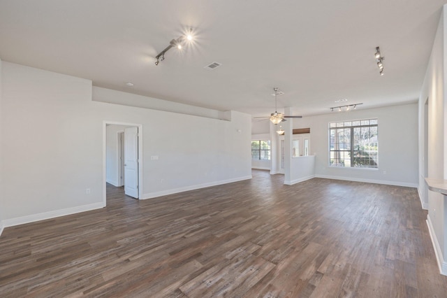 unfurnished living room featuring dark wood-style floors, ceiling fan, visible vents, and baseboards