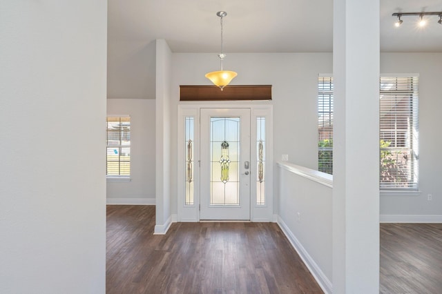 entrance foyer featuring track lighting, baseboards, and dark wood-style flooring