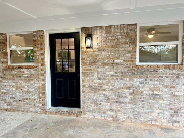 view of exterior entry featuring brick siding