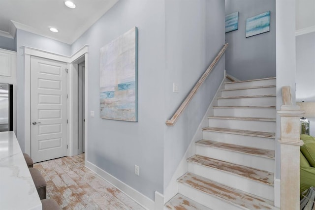 staircase with recessed lighting, baseboards, and wood finished floors