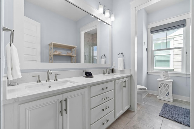 full bath with tile patterned flooring, toilet, baseboards, and a sink