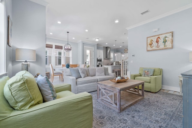 living area featuring stairway, baseboards, visible vents, recessed lighting, and ornamental molding