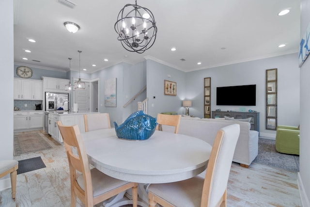 dining room featuring a notable chandelier, recessed lighting, crown molding, and visible vents