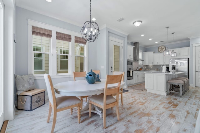 dining area featuring recessed lighting, visible vents, ornamental molding, and light wood finished floors