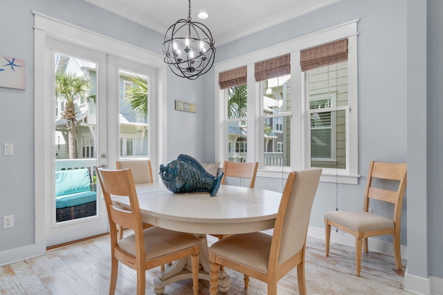 dining room featuring french doors, baseboards, a notable chandelier, and light wood-style flooring