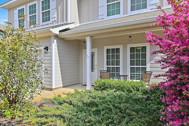 entrance to property with covered porch and board and batten siding