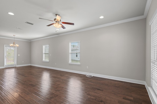 empty room with ornamental molding, dark wood-type flooring, visible vents, and baseboards