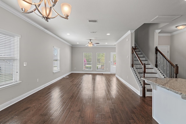 unfurnished living room featuring dark wood-style flooring, crown molding, visible vents, baseboards, and ceiling fan with notable chandelier