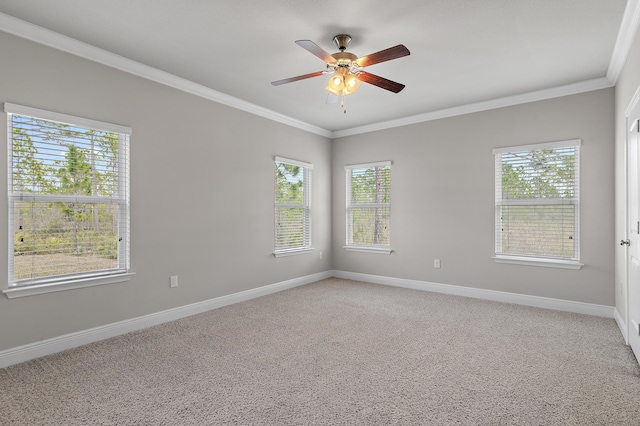 empty room featuring light carpet, a ceiling fan, baseboards, and crown molding