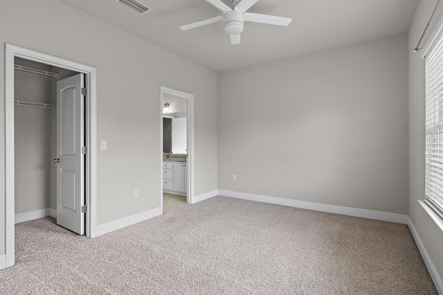 unfurnished bedroom with light carpet, a closet, visible vents, and baseboards