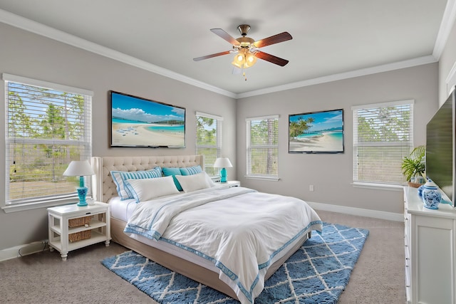 carpeted bedroom with multiple windows, crown molding, baseboards, and ceiling fan