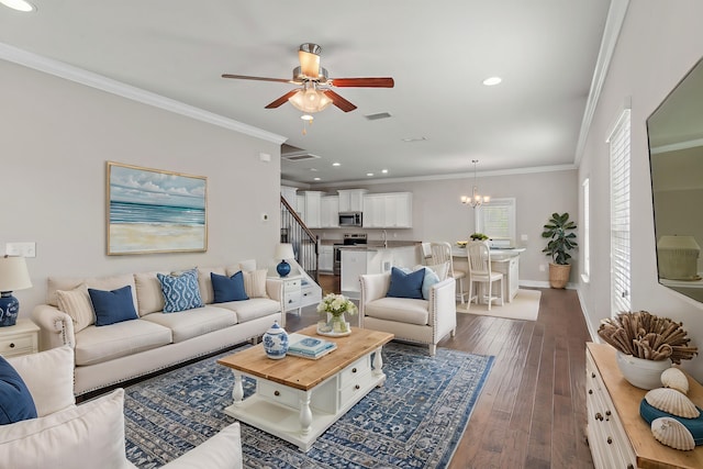 living room with dark wood-style floors, recessed lighting, visible vents, ornamental molding, and baseboards