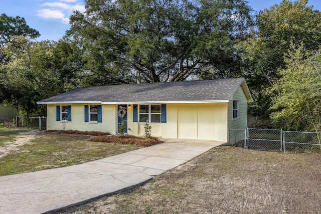 ranch-style home with roof with shingles, a gate, fence, and brick siding