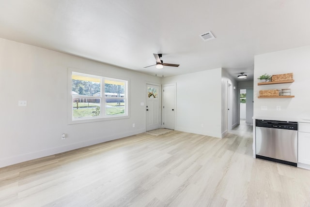 unfurnished living room featuring visible vents, ceiling fan, light wood-style flooring, and baseboards