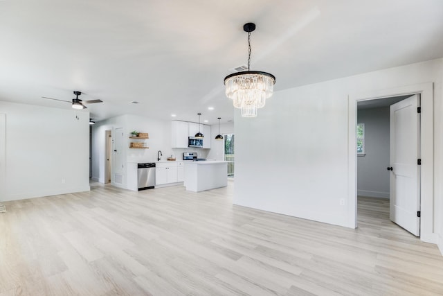 unfurnished living room featuring recessed lighting, ceiling fan with notable chandelier, visible vents, baseboards, and light wood-style floors