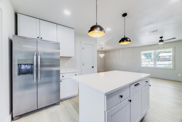 kitchen with light countertops, stainless steel refrigerator with ice dispenser, and white cabinetry