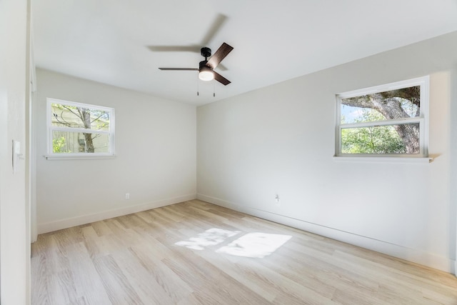 spare room with ceiling fan, baseboards, and wood finished floors