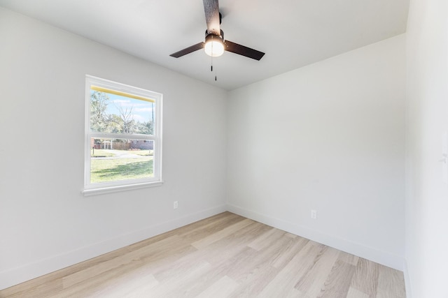 unfurnished room with light wood-style floors, ceiling fan, and baseboards