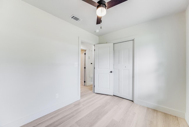 unfurnished bedroom with light wood finished floors, a closet, visible vents, and baseboards