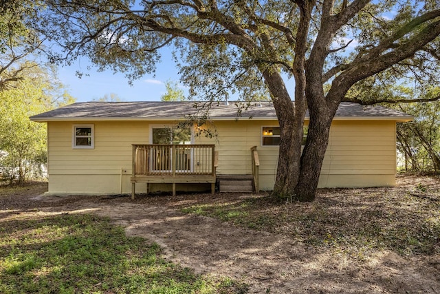 back of property with a wooden deck