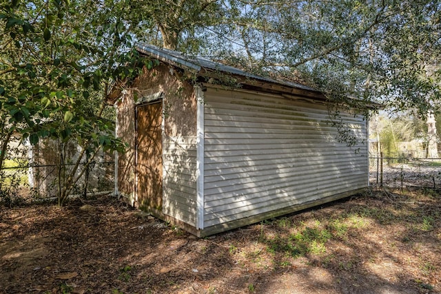 view of shed featuring fence