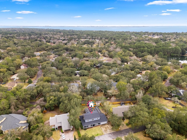 aerial view featuring a forest view and a water view