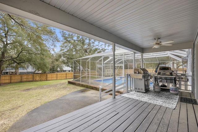 wooden terrace featuring glass enclosure, a fenced in pool, area for grilling, a yard, and a fenced backyard