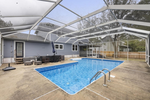 view of pool with entry steps, fence, a fenced in pool, a lanai, and a patio area