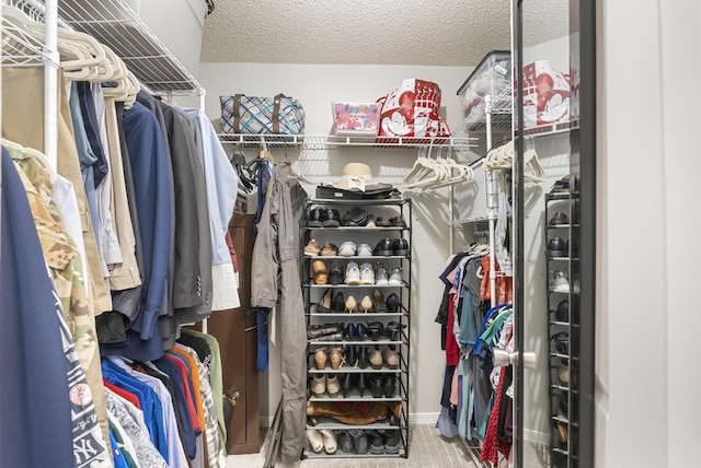 walk in closet with carpet flooring